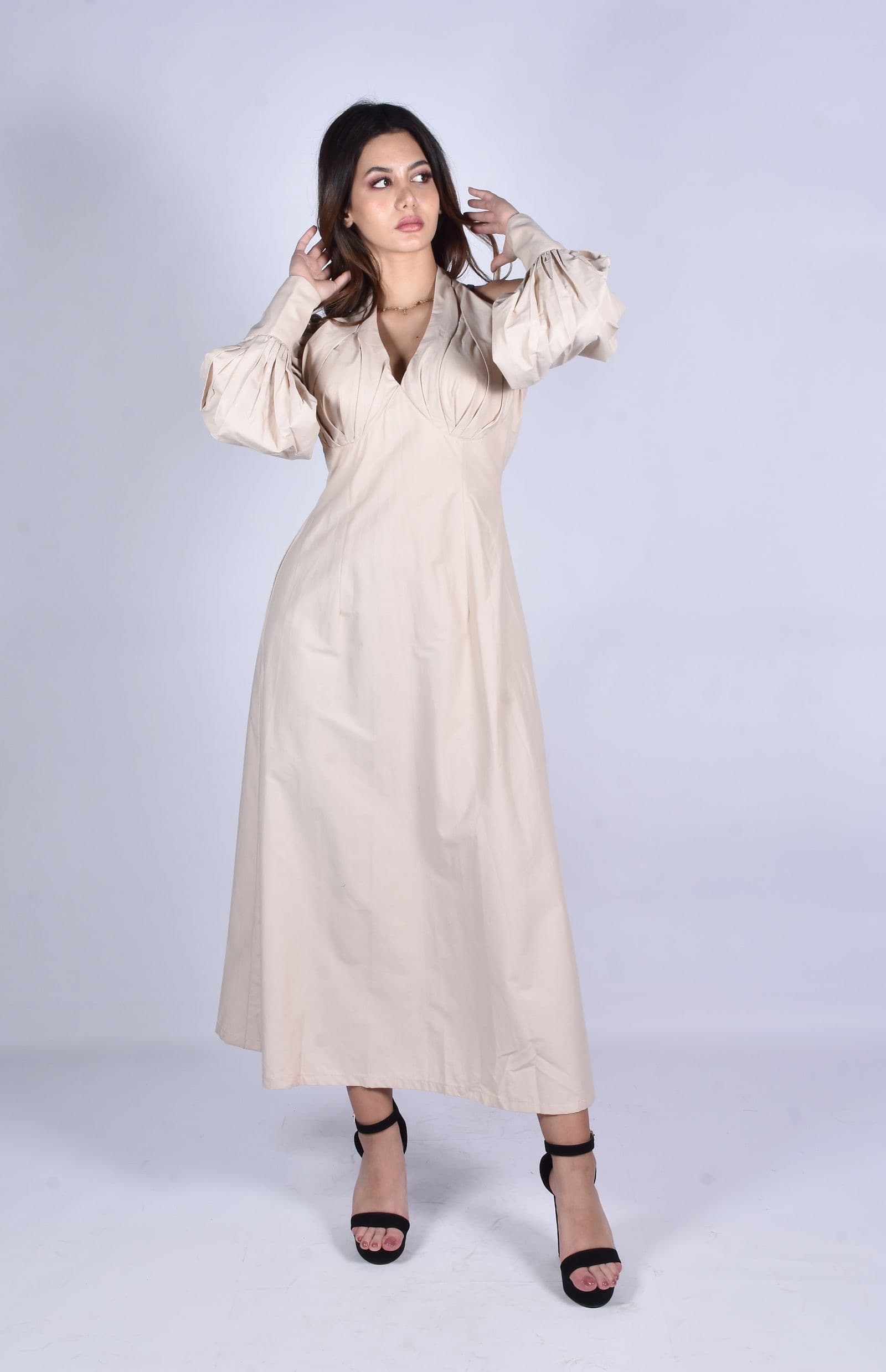 A model in a long ivory cotton dress