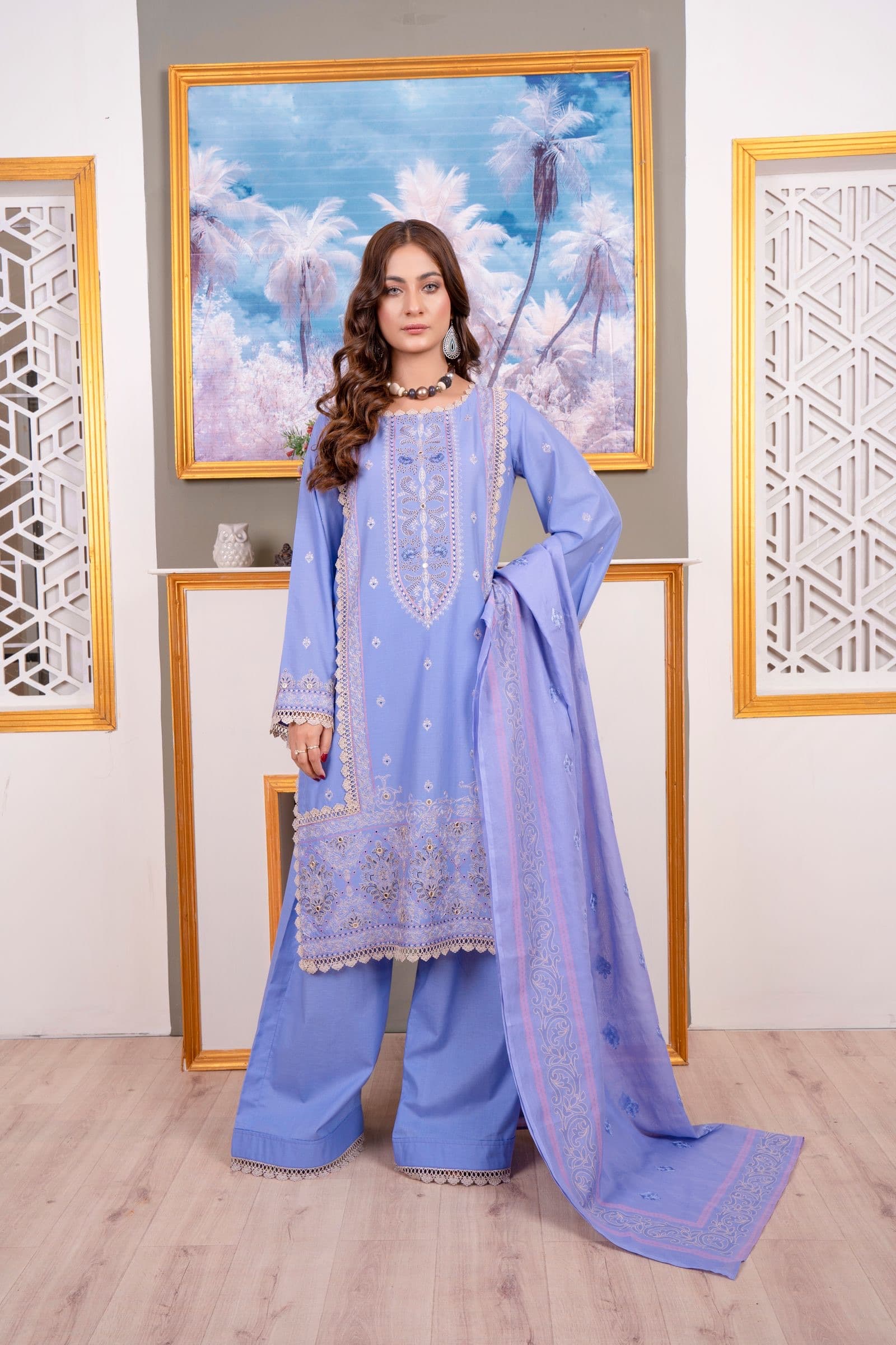 A model in a lavender embroidered kurta set with dupatta