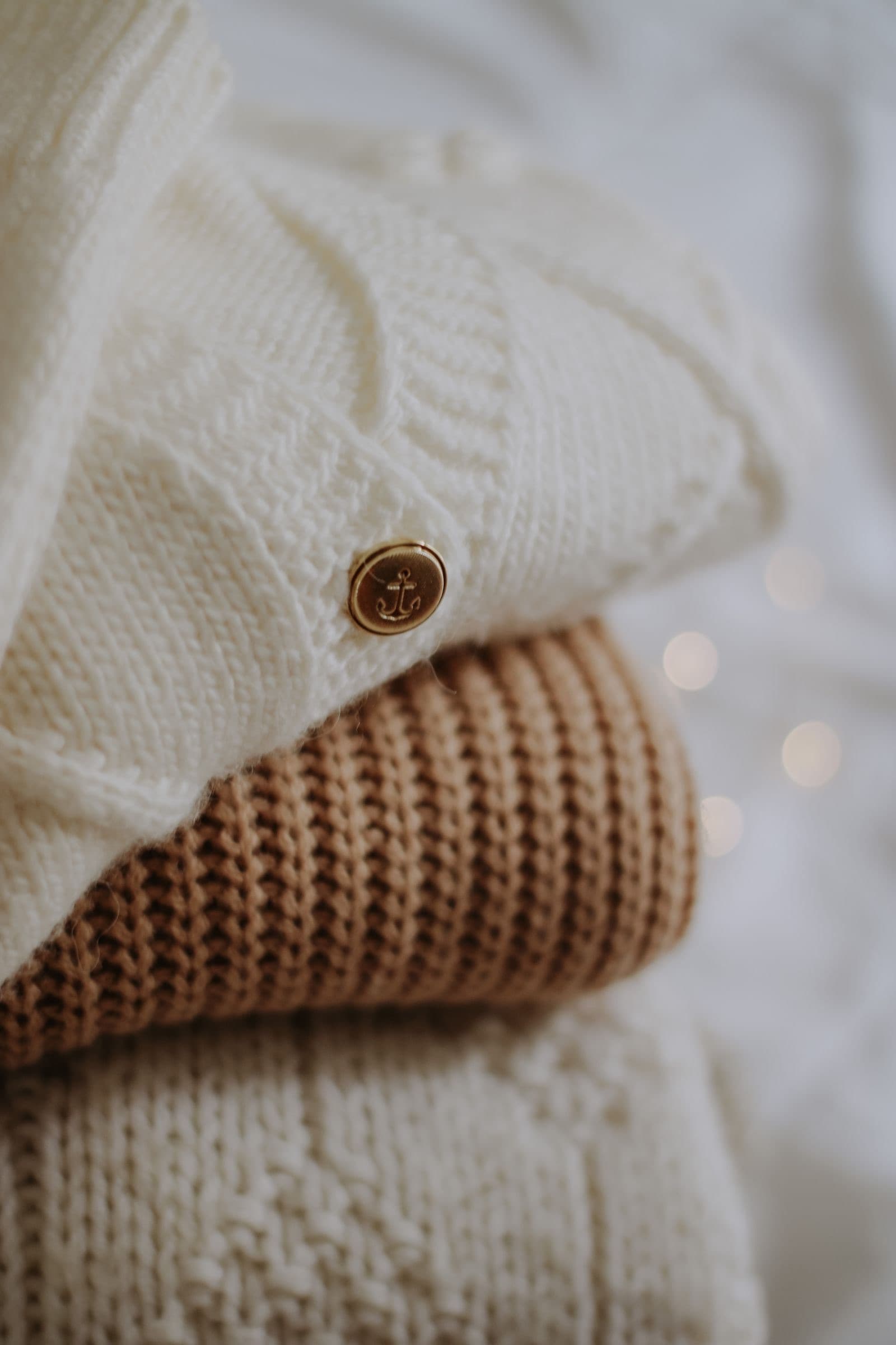 Close-up of an oat-coloured cable-knit sweater