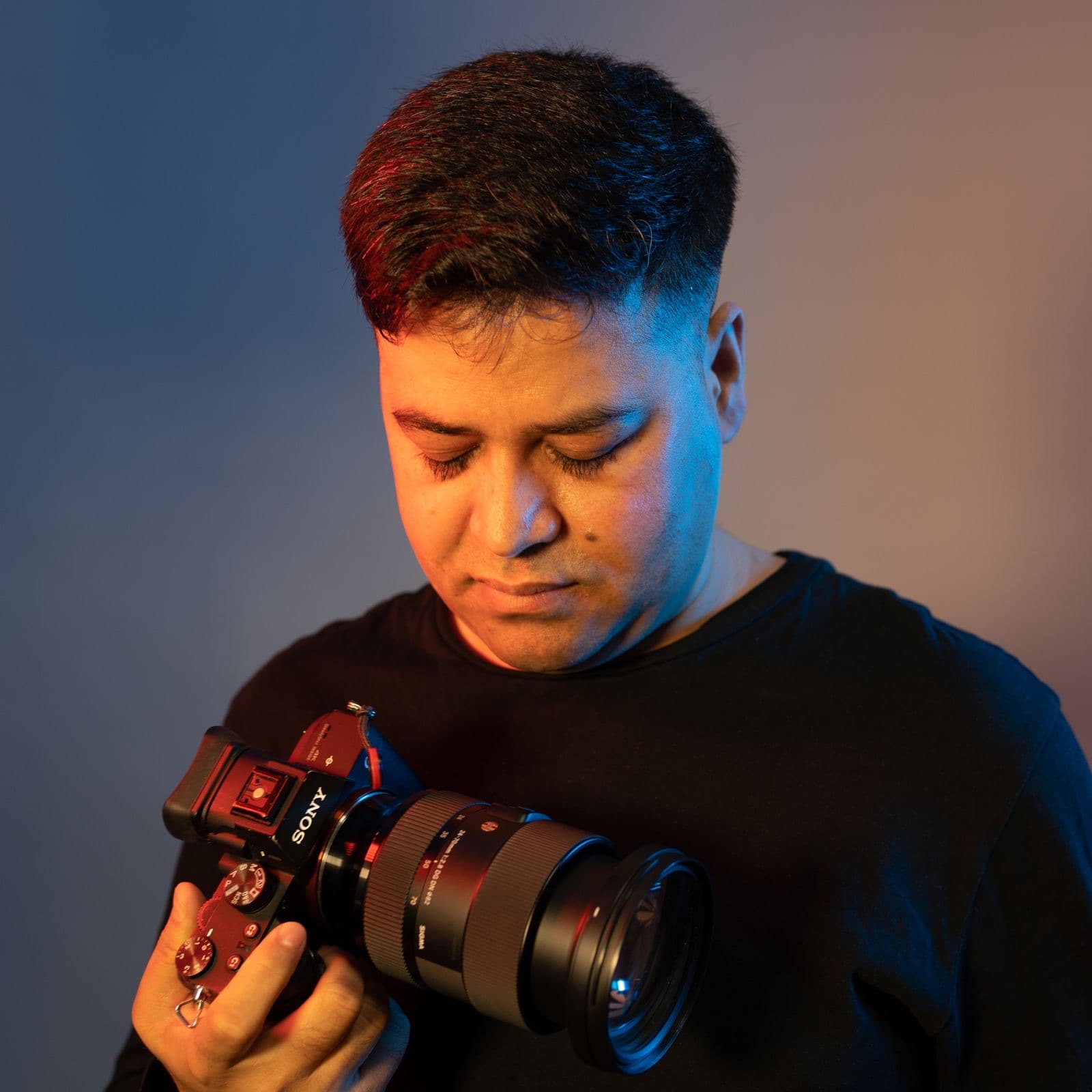 The photographer holding a camera in the studio