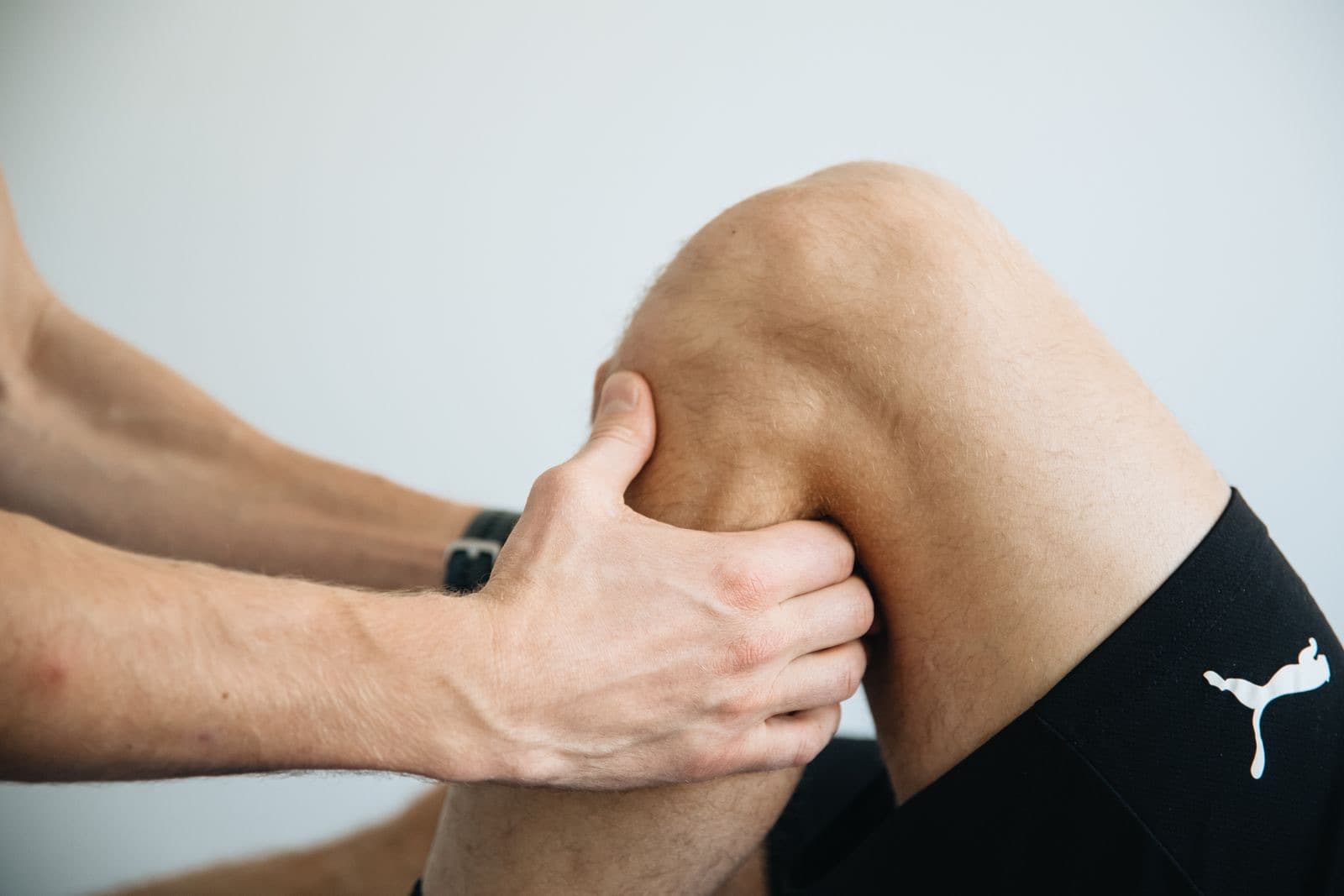 A physiotherapist working on a patient's knee