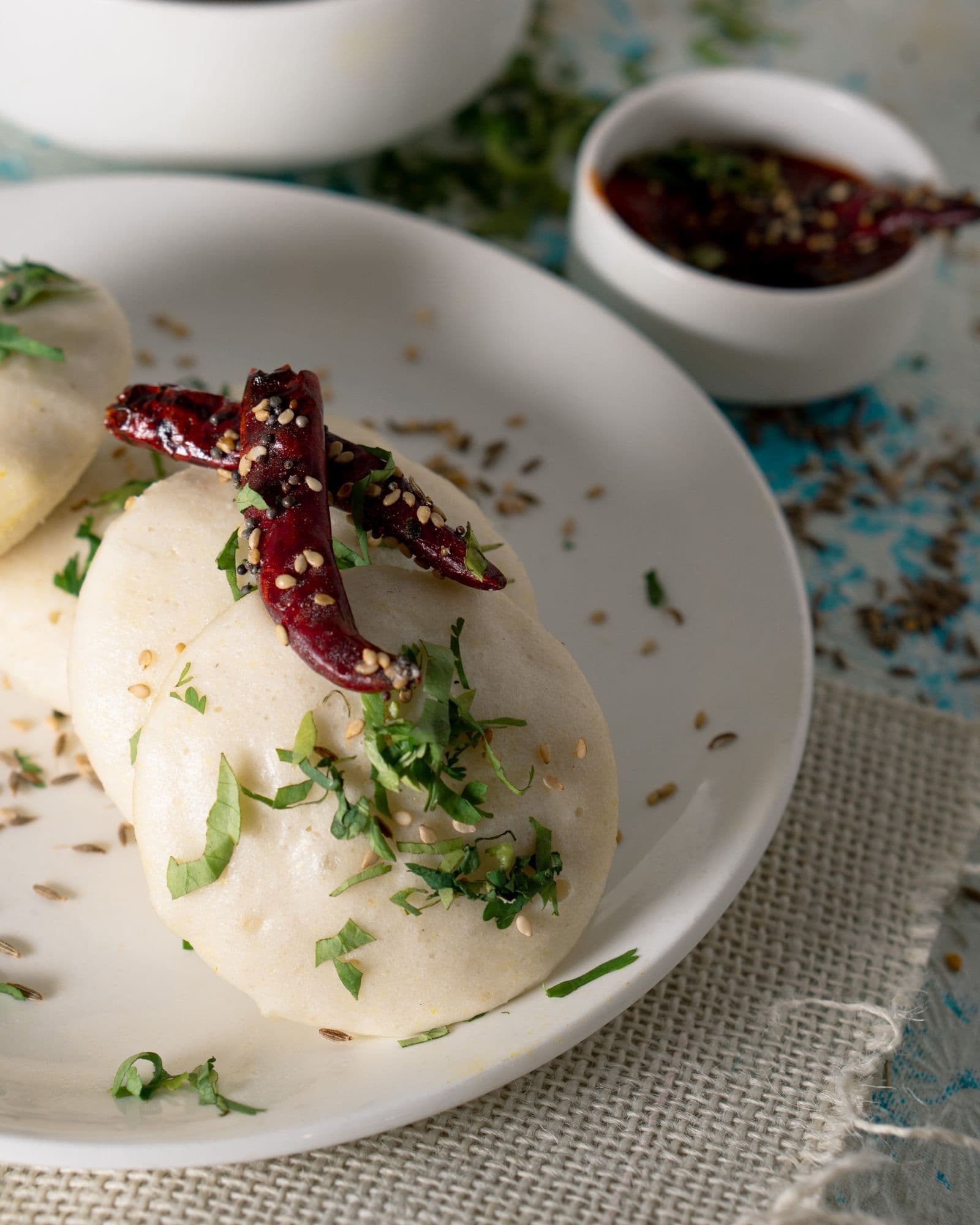 Soft steamed idli with a chilli and sesame tadka